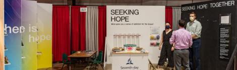 A view of Triadelphia Seventh-day Adventist Church’s “Seeking Hope” booth at the Howard County Fair in West Friendship, Maryland, in August 2021. From left: volunteers Callie Buruchara, Chandler Riley, and Brody Wiedemann. Credit Tony Williams 