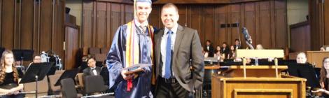 Zachary Macomber and Darren Wilkins, Spring Valley Academy principal, after graduation