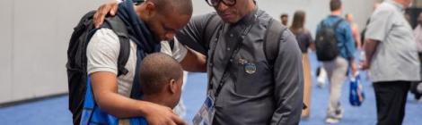  Sibusiso B. Khumalo, director of GC Youth Ministries, prays with a young person at the General Conference Session. Photo by Nicol Belvedere/AME (CC BY 4.0)