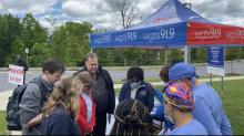 WGTS CEO Kevin Krueger prays with listeners at the prayer stop in front of Adventist HealthCare’s White Oak Medical Center in Silver Spring, Md.