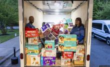WGTS 91.9 Hands and Heart volunteers Eric and Pat organize diapers in the box truck.