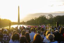 The sun rises over the Washington Monument.