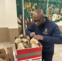 Robin Sampson, head deacon at the Capitol Hill church, packs bag lunches during the “Acts of Kindness” day.