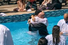 Carlos Quiroga, pastor of Nueva Esperanza church in Delaware, Ohio, embraces a newly baptized member.