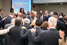 Columbia Union Conference Executive Committee members pray over President Marcellus T. Robinson. | Photo by Kelly Butler Coe