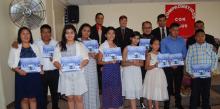 New members (front row) display their baptismal certificates.