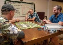 Scott Kabel (right) plays weekly board games with church and community members. Photo by David Butterfield