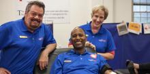 Jerry (center), pictured with Johnny and Stacey, donates blood during the blood drive.