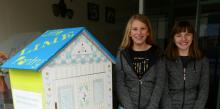 Kate Sharbaugh and Emma Schartner stand with one of their pantries.