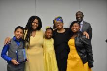 Maxine Forbes-Goulding and her former and current students and Sadrail Saint-Ulysse celebrate Forbes-Goulding's recent honor.