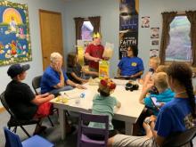 VBS leaders (in blue) teach about the character traits—truth and trusting—that Daniel and his friends relied on in Babylon.