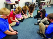 Students from the Mountain View Christian School in South Williamsport pray together.