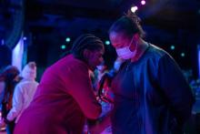 Pastor Cheryl Bridges prays with an attendee at WGTS' Night of Hope