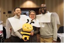 New Jersey Conference teachers Jason Chavez, Lilia Torres and John Hakizimana hold the conference’s mascot, Buzz the Bee, during a team exercise.