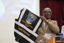 Kwabena Okyere, an elder who manages the church’s media and communication, displays one of the new volunteer vests to fellow church members.