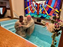 Marius Marton, pastor of the Elyria church, baptizes a new member.