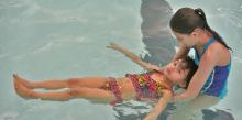 Kristiana Hoffman instructs one of her students during a swim class. Photo by Laura Hoffman