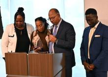 Celeste Blyden, Marcellus Robinson and Emmanuel Asiedu surround Gina Brown as she prepares to serve as president of Oakwood University.