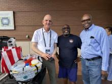 Sligo church member Anees Abdelnour (left) and Agape church members Lionel Bailey and Jornas Pierre lend a helping hand to refugee families in St. Louis.