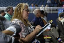 Reina Zapata-Mendez, a delegate to the General Conference Session and lay member from the New Jersey Conference, diligently takes notes during the business proceedings. Photo by Kelly Butler Coe.