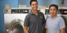 Ross Patterson photographed Enactus member Levi Soares and owner Nok Kim in the Rainbow Coin Laundry in Silver Spring, Md.,