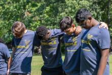 Lucas Chow (’27), William Miongo (’27), Andrew Pozo (’28) and Samuel Joel (’28) pause to pray during the academy’s spiritual retreat.