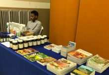 Wellness instructor Ezra St. Juste staffs the natural remedy literature display table at the Community Health Expo.