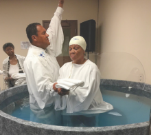 Stephen D. Lewis, pastor of the Dayton church, baptizes Brenda Rutledge.