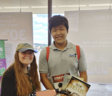 Joosung Kim, a member of the Impact Magabook Ministries team, displays his books alongside his new friend.