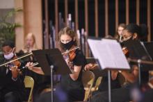 Strings players Joseph Pelote (’24), Ellie Anderson (’23) and Anisa Phillip (’24) perform during the annual Candlelight Concert.
