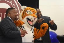 Tiger, Takoma Academy’s mascot, is flanked by Vice Principal Keith Beckett and alumnus Melvyn Hayden III (’89).