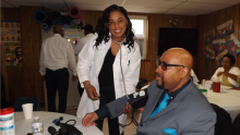 Willow Grove church member Rosemarie Webster takes blood pressure from frequent visitor Dornell LaVant during the Community Outreach Day.