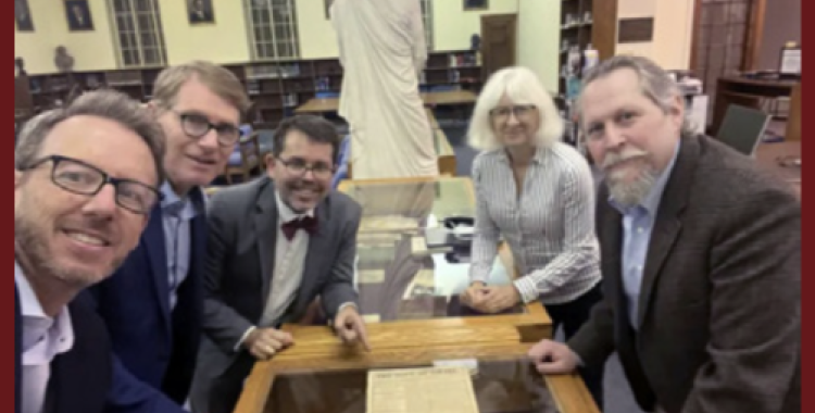 Jonathan Scriven, Nicholas P. Miller, Michael W. Campbell, Kathy Hecht, and Bradford Haas take a photo of the document with historical ties to the founding of the Seventh-day Adventist Church. [Photo: courtesy of Michael Campbell]