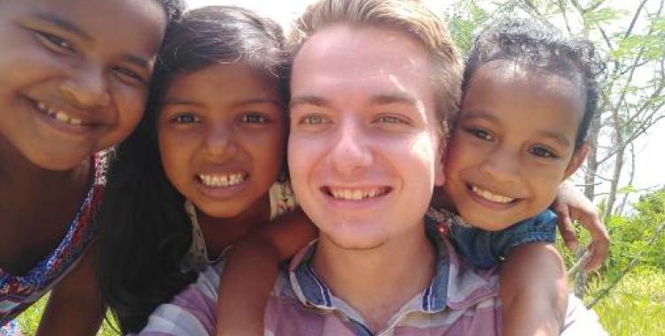 Student missionary Nathan Moravetz hangs out with three church friends in Yap.