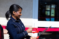 Delaina Cox, Finance Committee chairperson for  Columbus Adventist Academy, cuts the ribbon to celebrate the school’s expansion.