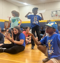 Campers Annelise Cruz, Liam Brewer (standing) and  Daniel Jones prepare for a fun day at camp.