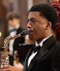 Junior Malachi McRoy plays the saxophone during  the Concert Winds music tour. 