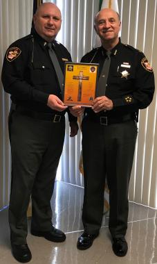 Marius E. Marton (left) presents Lorain County Sheriff Phil R. Stammitti with a certificate of appreciation.