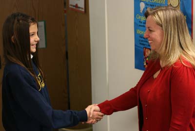Raquel Fuller, a student at Olney Adventist Preparatory School in Olney, Md., practices etiquette with principal Jami Walker.