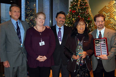 Hospital administrators present Ester Bacud (second from right) her Compassionate Care Award.