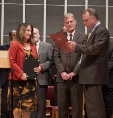 Bill Miller (right), president of the Potomac Conference, presents Debbie Eisele, a pastor at Sligo church in Takoma Park, Md., with her ordination certificate.